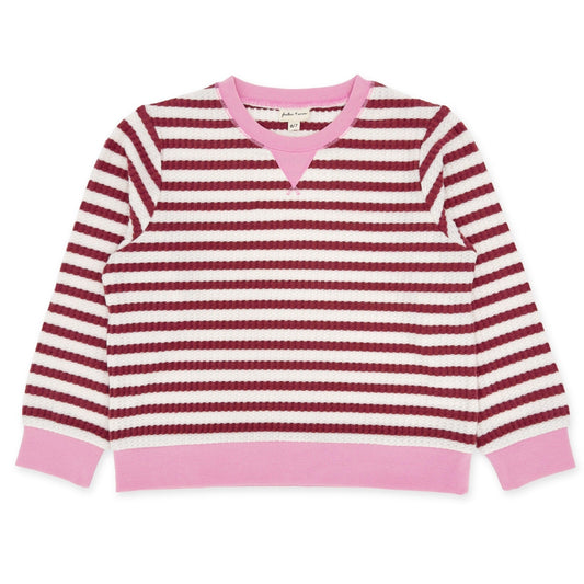 Pink and red striped sweater on a white background