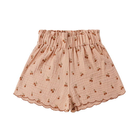 Pink shorts with a subtle pattern and scalloped trim. 