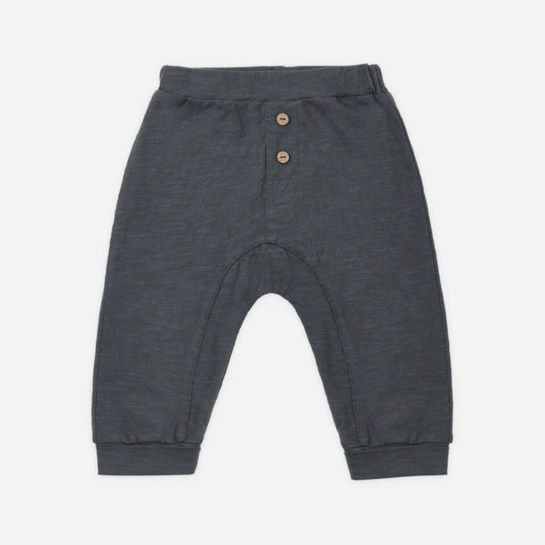 Dark gray heathered knit pants for babies, featuring a buttoned henley waistband with two small wooden buttons, elastic cuffs, and a curved leg design, shown flat on a light gray background.