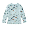 A light blue long-sleeve children's top with an allover pattern of small cars in navy, teal, and brown, featuring a left chest pocket.