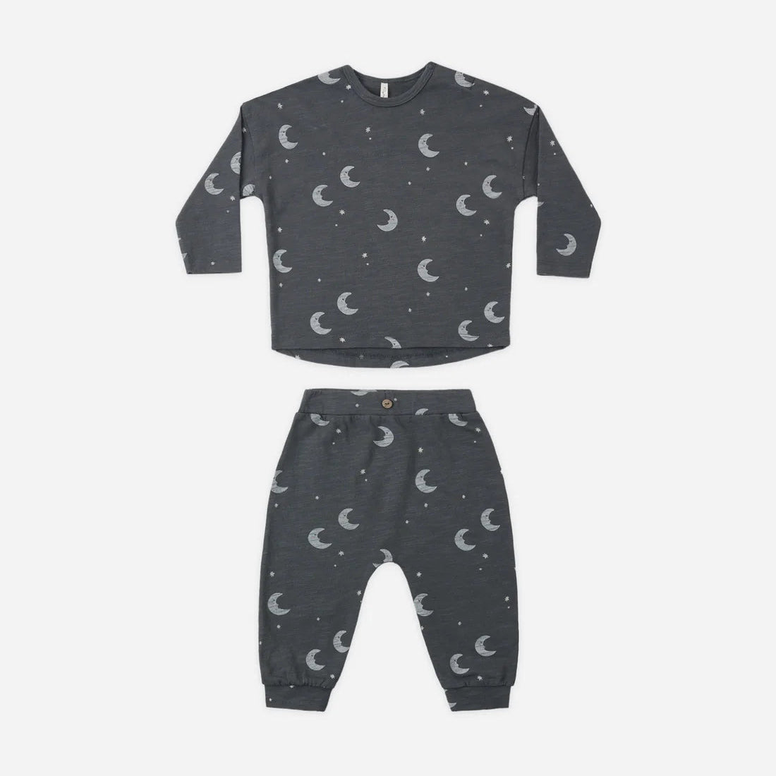 A two-piece children's pajama set in dark gray with a white crescent moon and star pattern, consisting of a long-sleeve top and matching pants, laid flat on a white background.