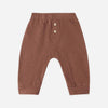 A pair of toddler's brown pants with a buttoned henley waistband, displayed flat against a light gray background.