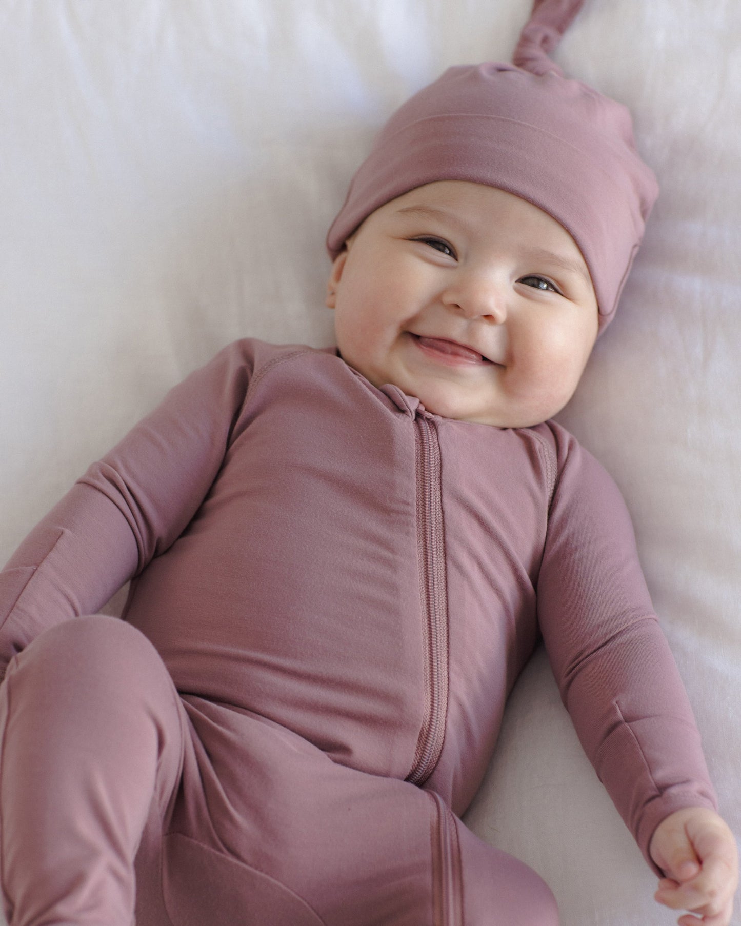 Baby wearing the Mulberry Bamboo Zip Footie, lifestyle photo