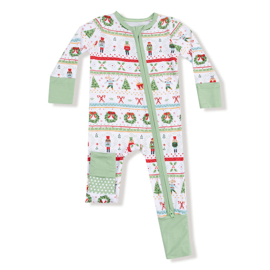 Christmas-themed baby zip romper with a pattern of trees, presents, and reindeer on a white background.