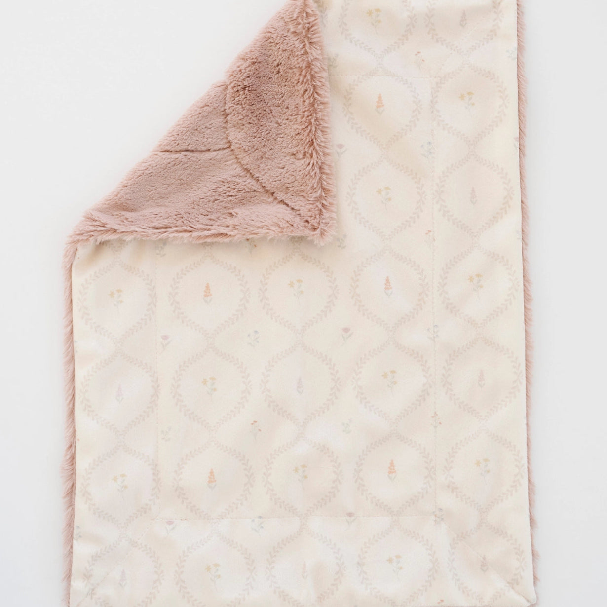 Blanket with textured surface and pink lush underside