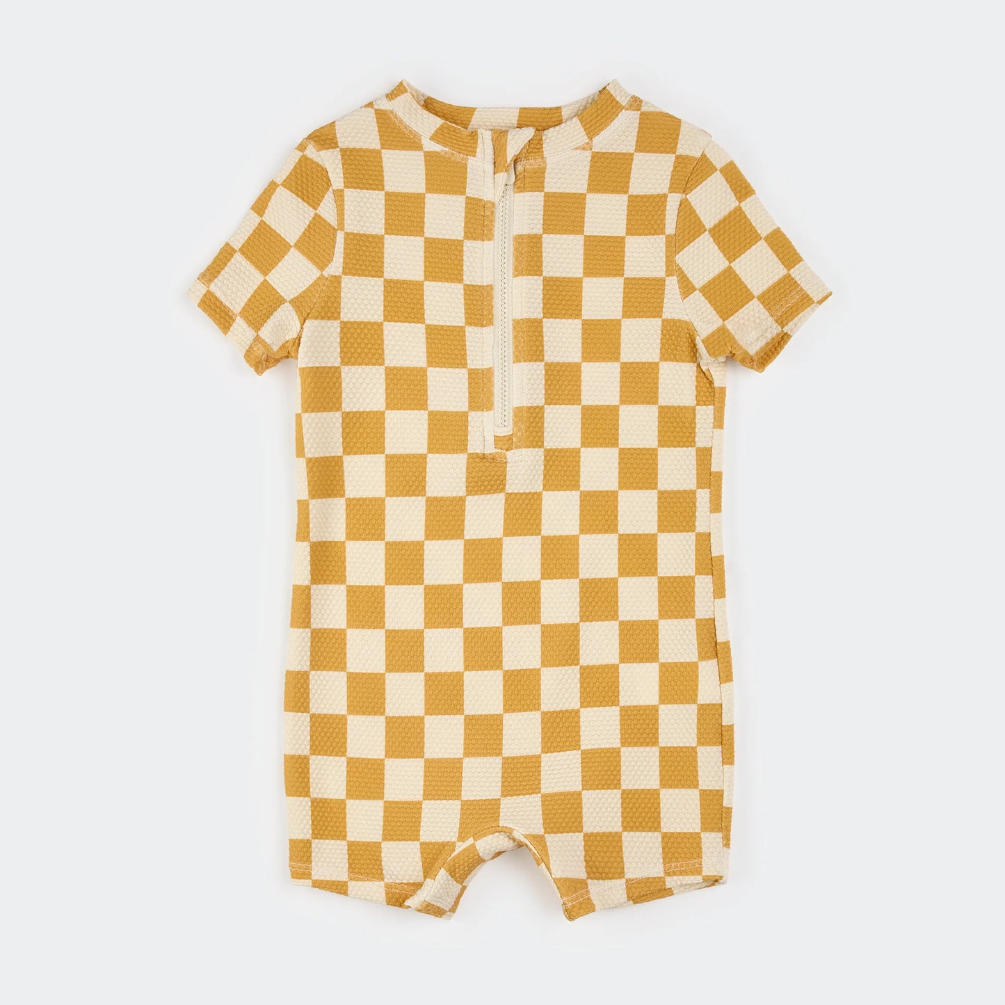 Quarter zip rash guard with mustard and cream colored checker board pattern
