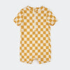 Quarter zip rash guard with mustard and cream colored checker board pattern