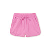 A pair of pink gym shorts with a drawstring waist and pom-pom trim, designed for children.