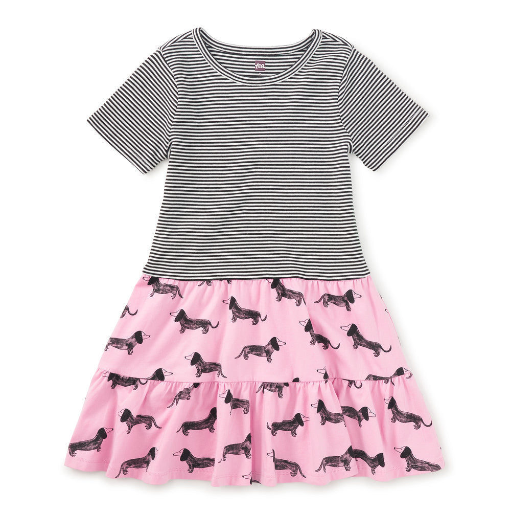 Two-tone dress with striped bodice and pink skirt with dog pattern on a white background