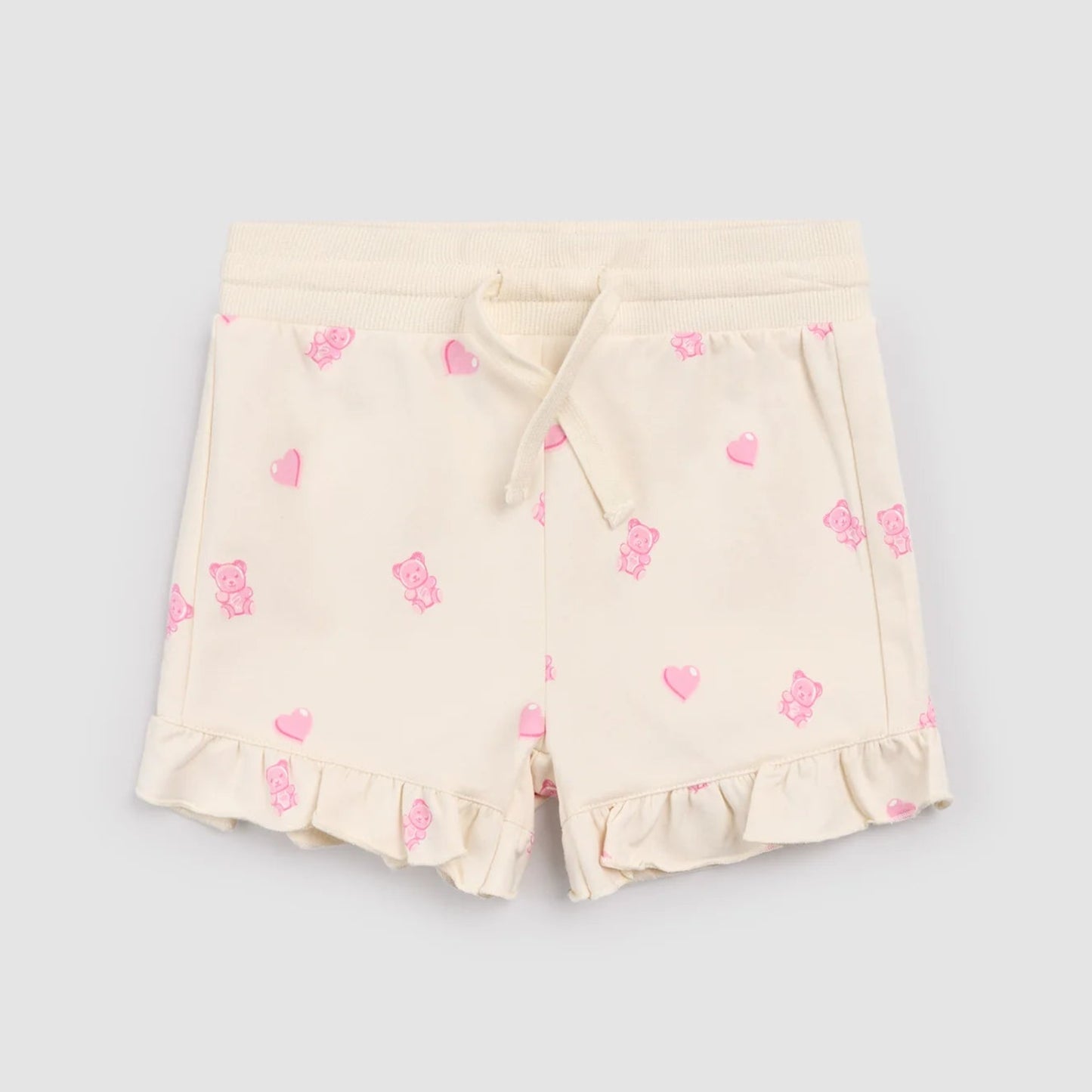 Cream shorts with pink gummy bears and heart patterns
