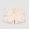 Cream shorts with pink gummy bears and heart patterns