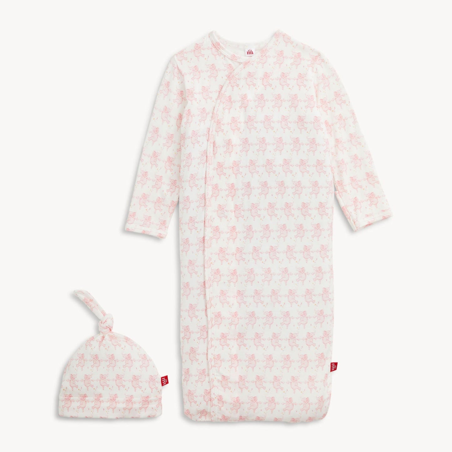 Baby onesie with pink floral pattern and matching hat on a white background