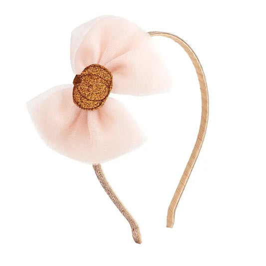 Headband with pink bow and gold center on a white background