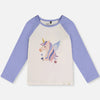 A children's long-sleeve raglan top with a cream body and light purple sleeves, featuring a colorful winged unicorn graphic on the chest.