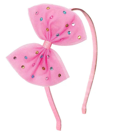 Pink headband with large bow and colorful embellishments on a white background