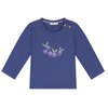 A long-sleeve baby t-shirt in periwinkle blue, featuring a small embroidered graphic of purple berries with green leaves on the chest. The shirt has adjustable shoulder snaps and is displayed flat against a solid white background.