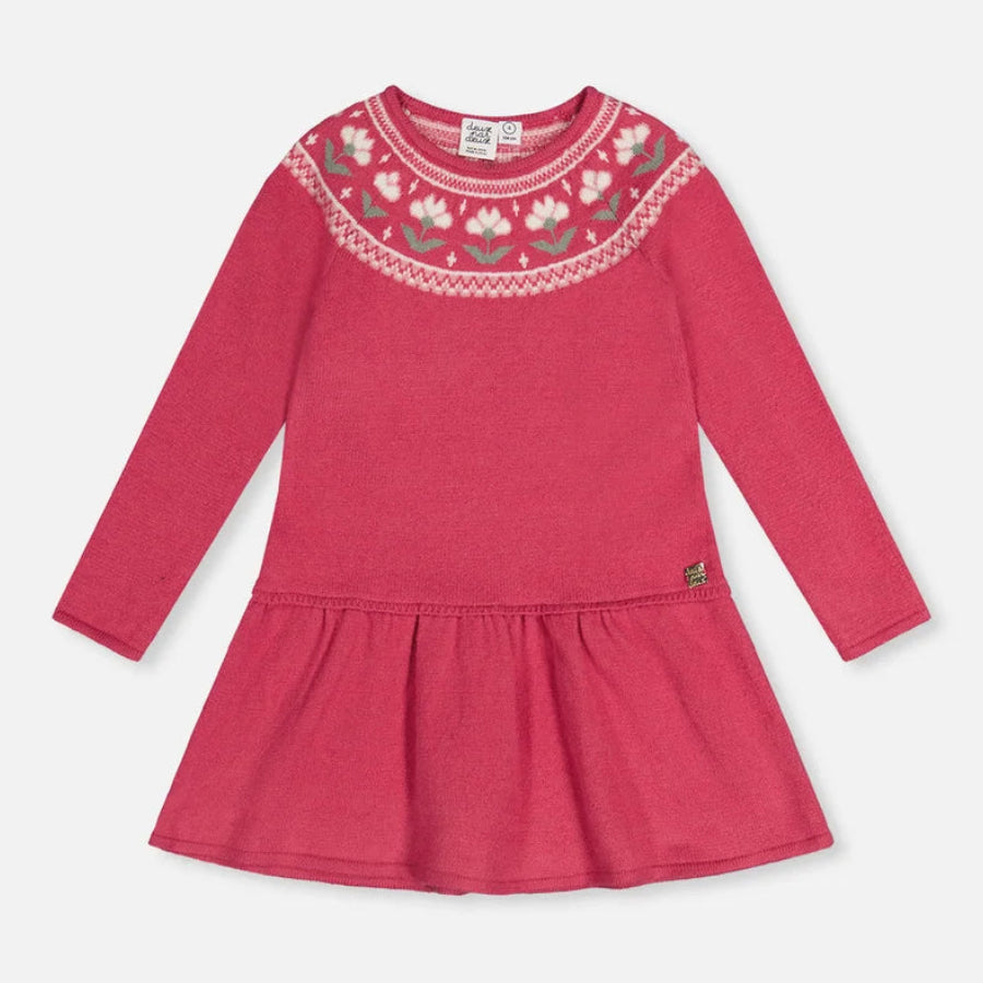 A pink long-sleeve baby dress with a gathered peplum waist and a decorative embroidered yoke featuring white and green floral details, shown on a light gray background.