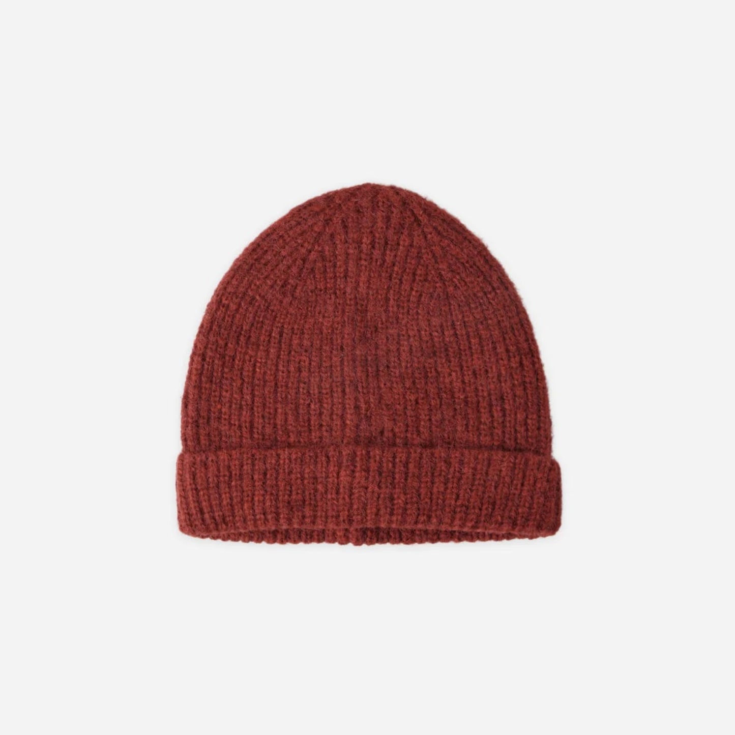 Red knit beanie on a light beige background