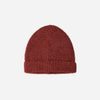 Red knit beanie on a light beige background