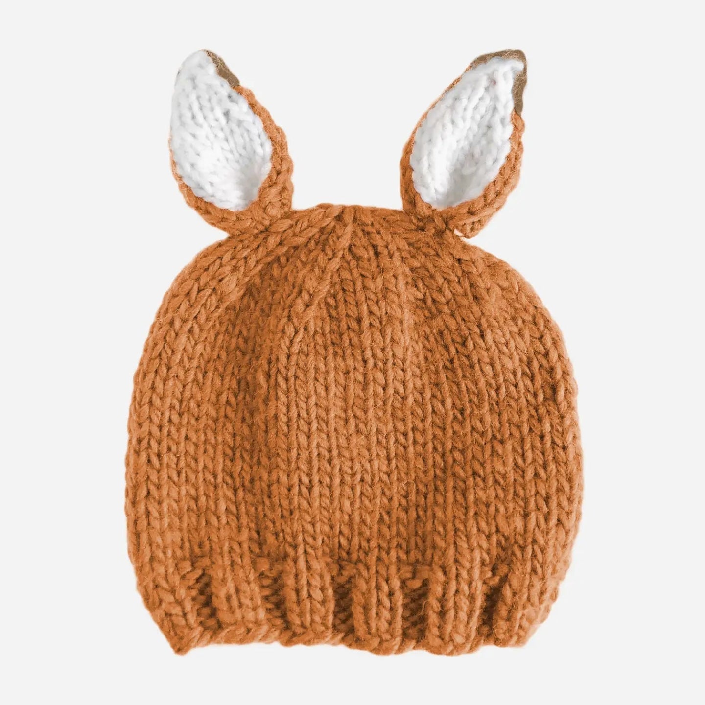 A chunky knit baby beanie hat in a warm rust brown color, featuring two upright bunny ears with white inner linings, shown against a plain light gray background.