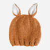 A chunky knit baby beanie hat in a warm rust brown color, featuring two upright bunny ears with white inner linings, shown against a plain light gray background.