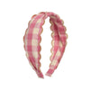 Pink and white checkered headband with scalloped edge on a white background