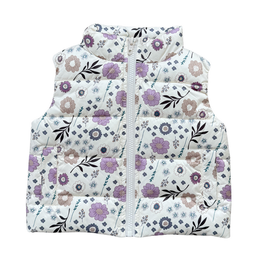 Floral patterned puffer vest on a white background