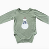 Green baby onesie with a snowman design on a white background
