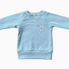 Light blue sweatshirt with a design on a white background