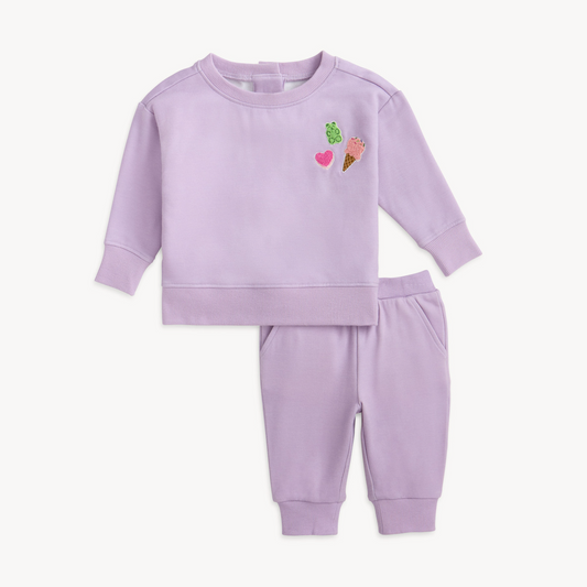 Lavender children's sweatshirt and pants set with embroidered designs on a white background