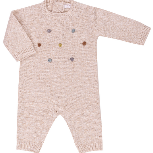 Beige knitted baby romper with colorful polka dots on a white background