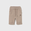 Beige baby pants with a small logo on a light gray background