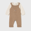 Brown ribbed baby overalls with a white shirt underneath on a light gray background