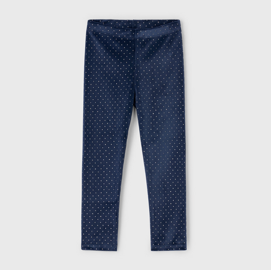 Navy blue leggings with white polka dots on a light gray background