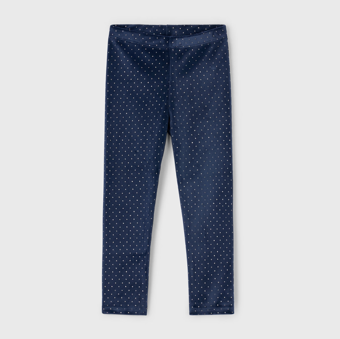 Navy blue leggings with white polka dots on a light gray background