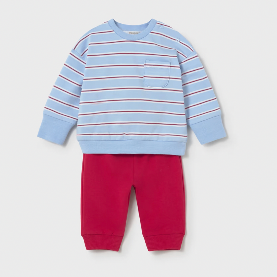 Children's outfit with a blue and red striped sweatshirt and red pants on a light gray background