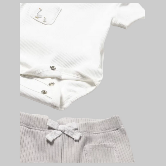 White ribbed onesie and shorts on a light gray background