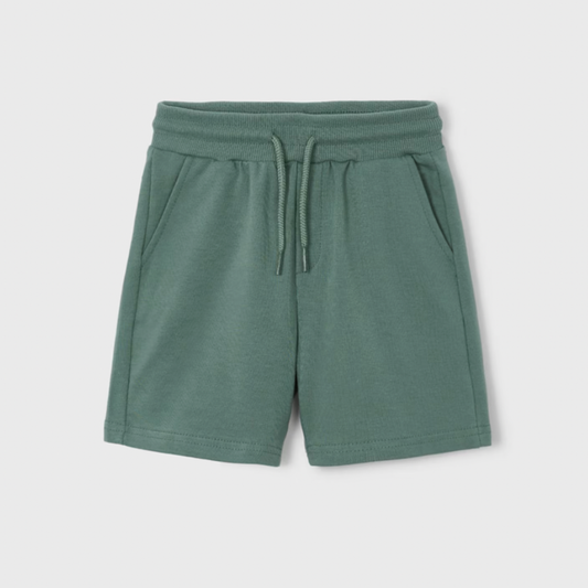 Green shorts with a drawstring on a light gray background