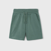 Green shorts with a drawstring on a light gray background