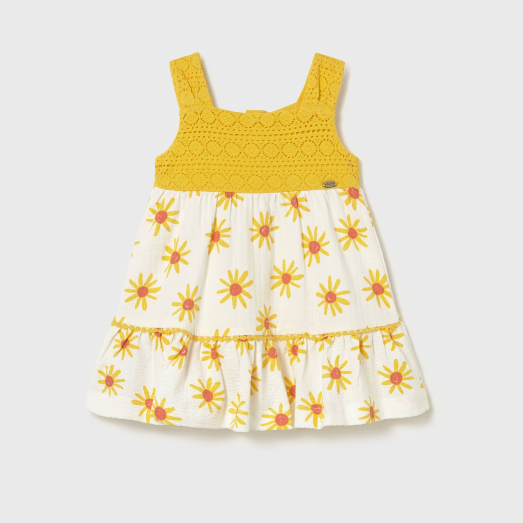 Yellow and white dress with floral pattern on a light gray background
