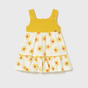 Yellow and white dress with floral pattern on a light gray background