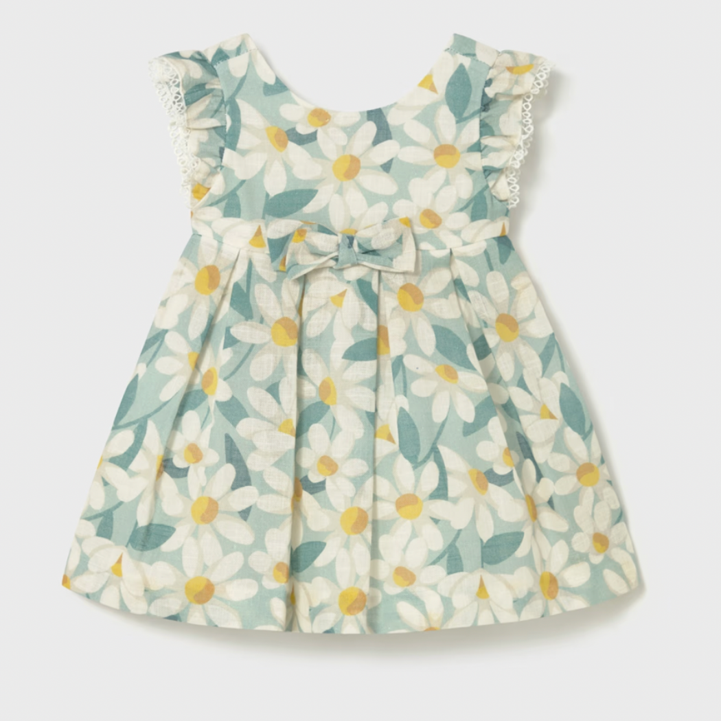 Floral dress with white flowers and green leaves on a light gray background