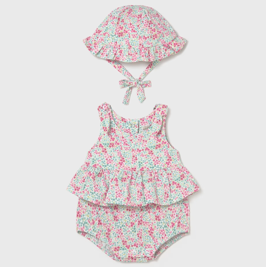 Floral baby romper with hat on a white background