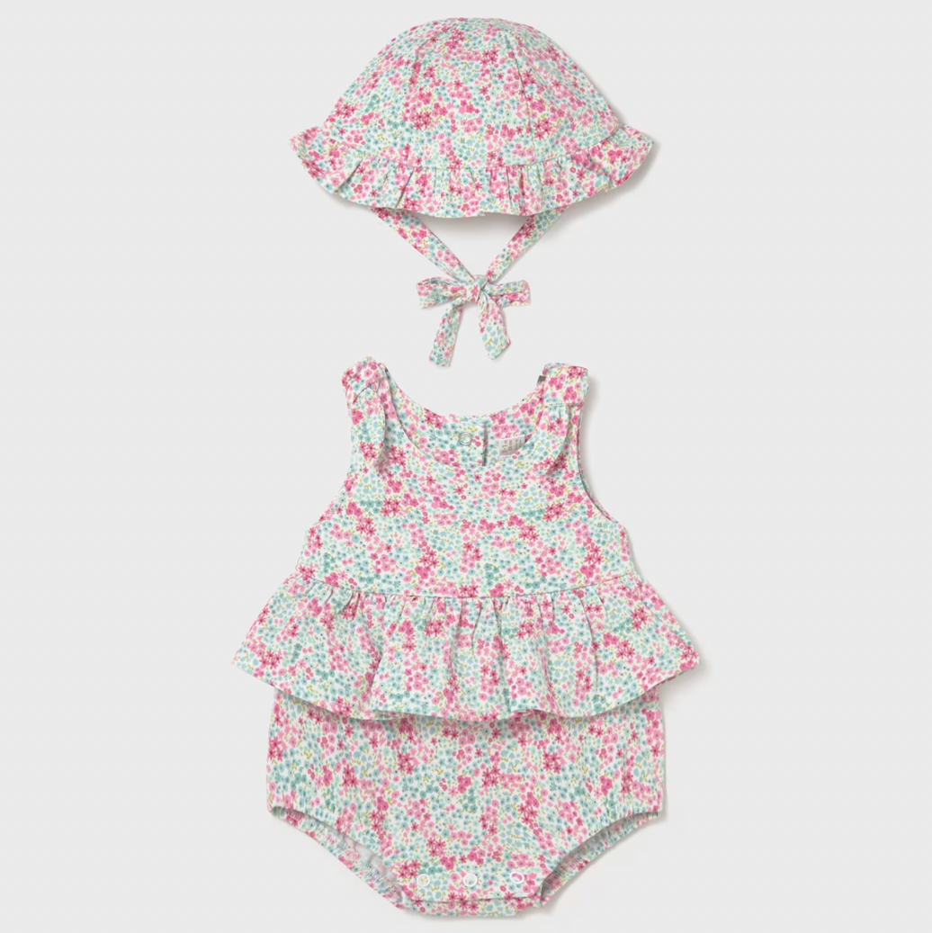 Floral baby romper with hat on a white background