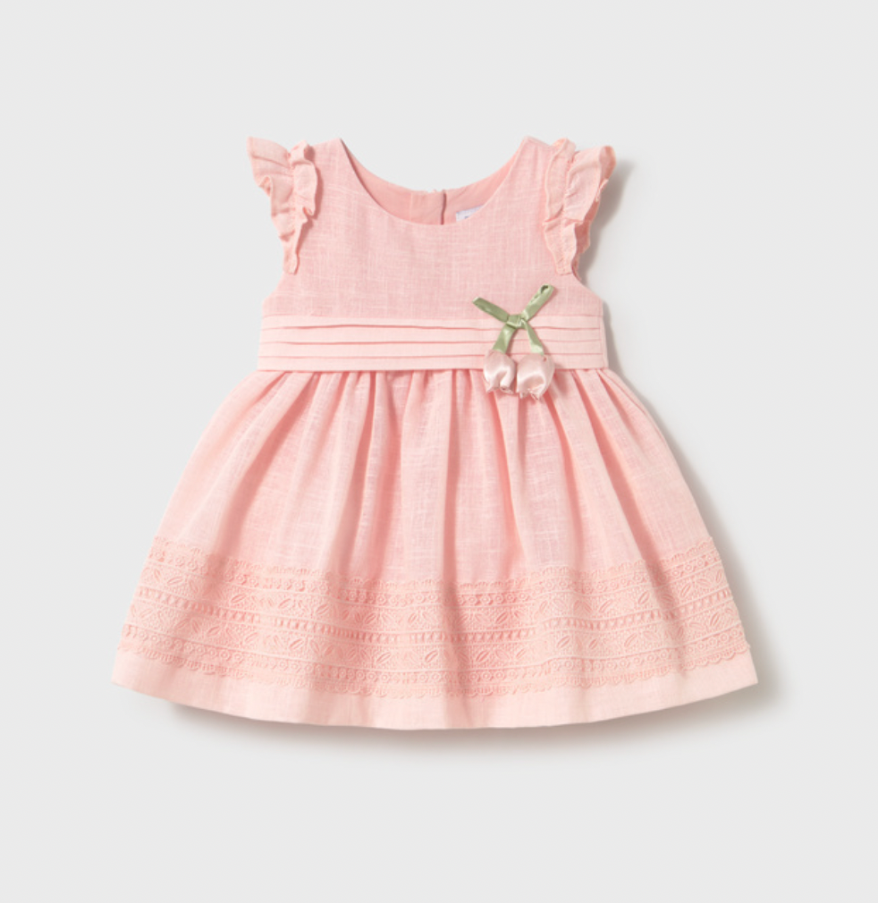 Pink dress with ruffled sleeves and a bow on a light gray background