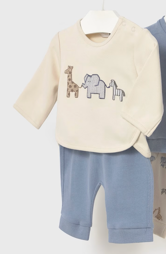 Baby outfit with cream top and blue pants featuring animal designs on a white background