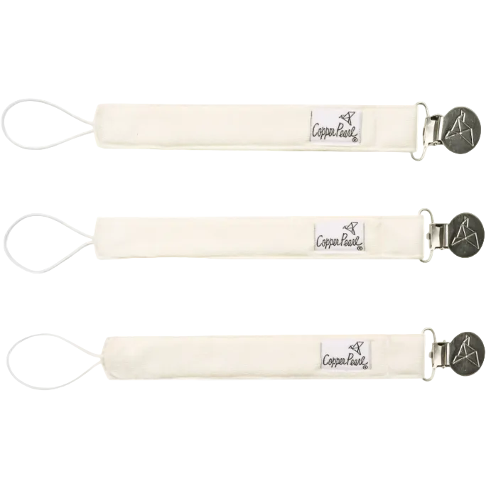 Three cream-colored baby bottle holders with metal clips on a white background