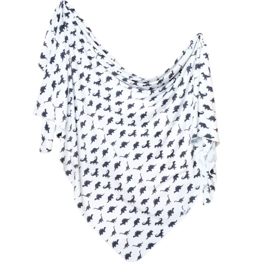 White fabric with black dinosaur pattern on a white background