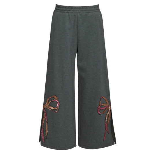 Gray wide-leg pants with decorative sequin bow on side next to slit