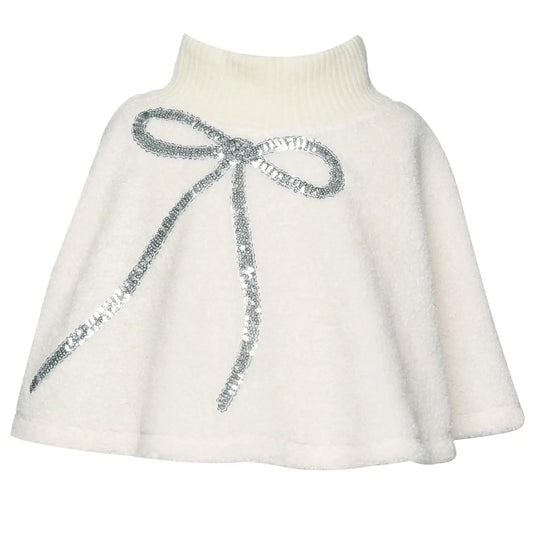 White knit sherpa poncho with a silver sequin bow on a white background